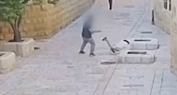 photo screenshotted from cctv video published by israeli police video showing a christian nun lying on the floor after being violently attacked by a jewish illegal israeli settler.